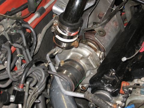 1991 Mitsubishi 3000GT - Engine bay view showing a turbocharger, intake piping, and associated hoses.