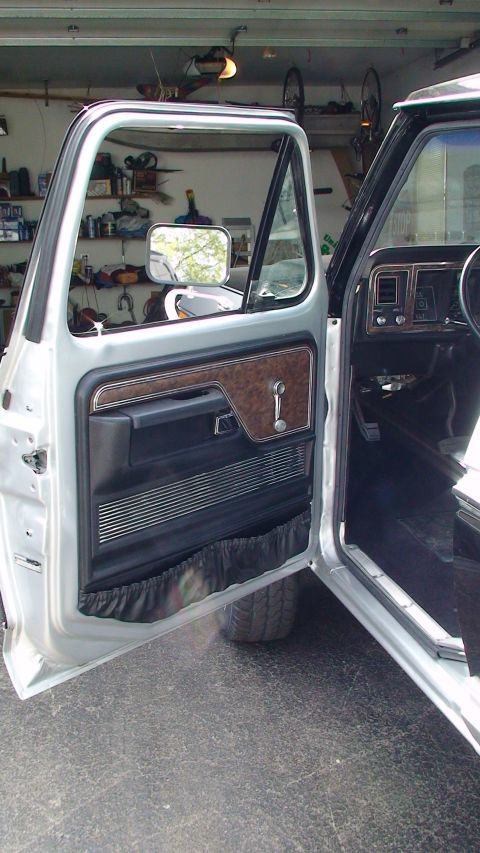 1979 Ford Bronco - Interior view of a 1979 Ford Bronco, highlighting the door panel details and dashboard.