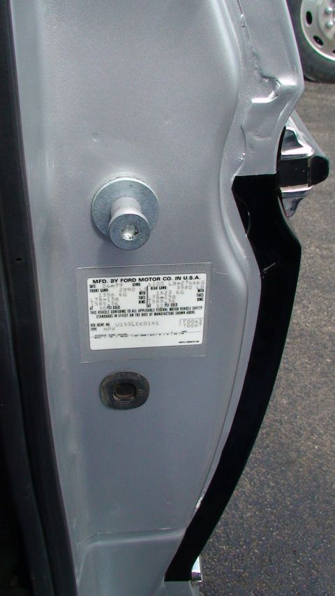 1979 Ford Bronco - Close-up of a vehicle's door jamb sticker showing identification details.