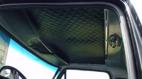1979 Ford Bronco - Interior view of a vehicle's cabin, highlighting the diamond-stitched headliner and a sun visor.