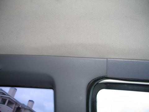 1995 Mercury Cougar - The interior of a vehicle is shown, focusing on the headliner and window frame, with a website watermark present.
