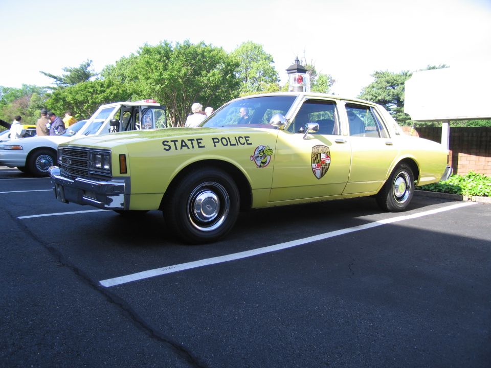 Yellow Maryland State Police Caprice sedan parked at a car show