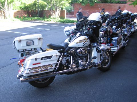 1991 Ford LTD Crown Victoria - white-and-black Sheriff Harley-Davidson police motorcycle parked first in a row of police motorcycles.
