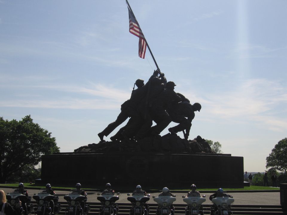 Iwo Jima memorial statue with a row of motorcycles in the foreground