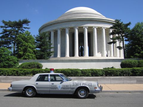 1991 Ford LTD Crown Victoria - gray Rhode Island State Police sedan parked along a curb in front of the columned, domed Jefferson Memorial.