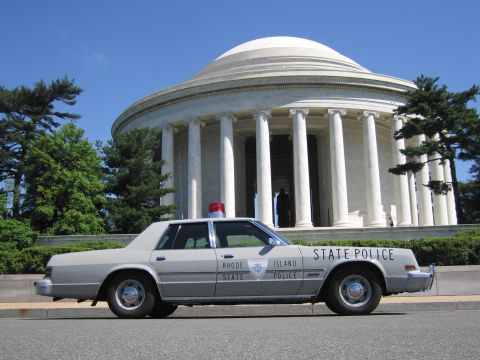 1991 Ford LTD Crown Victoria - gray Rhode Island State Police sedan with chrome trim parked before the white domed, columned Jefferson Memorial.