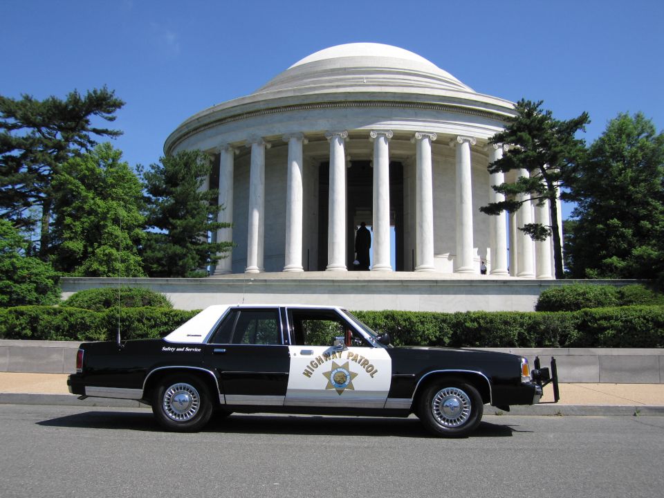 Black-and-white Highway Patrol sedan parked at the Jefferson Memorial