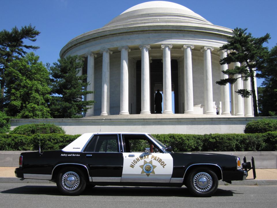 Side view of black-and-white Highway Patrol sedan at the Jefferson Memorial