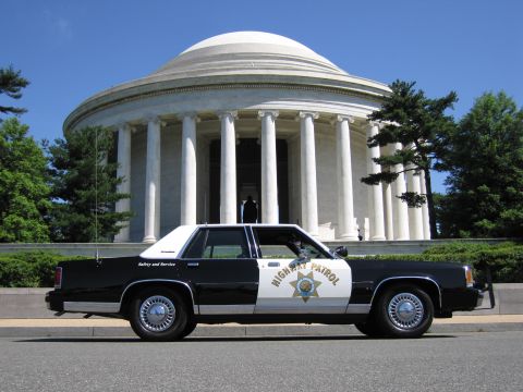 1991 Ford LTD Crown Victoria - black-and-white Highway Patrol sedan parked in profile before the white domed, columned Jefferson Memorial.