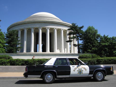 1991 Ford LTD Crown Victoria - black-and-white Highway Patrol sedan with a star shield parked before the white columned, domed Jefferson Memorial.
