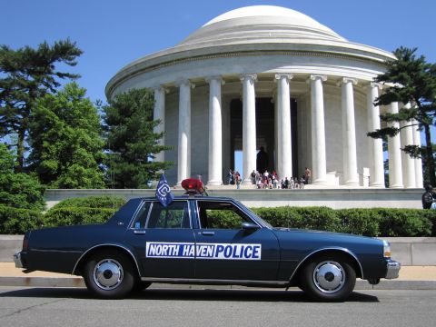 1991 Ford LTD Crown Victoria - dark blue North Haven Police sedan in profile before the columned Jefferson Memorial with visitors on the steps.