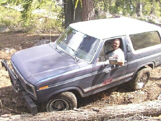 1986 Ford Bronco - This Ford Bronco appears to be from the early 1980s, not 1986, as it navigates a rough off-road path.