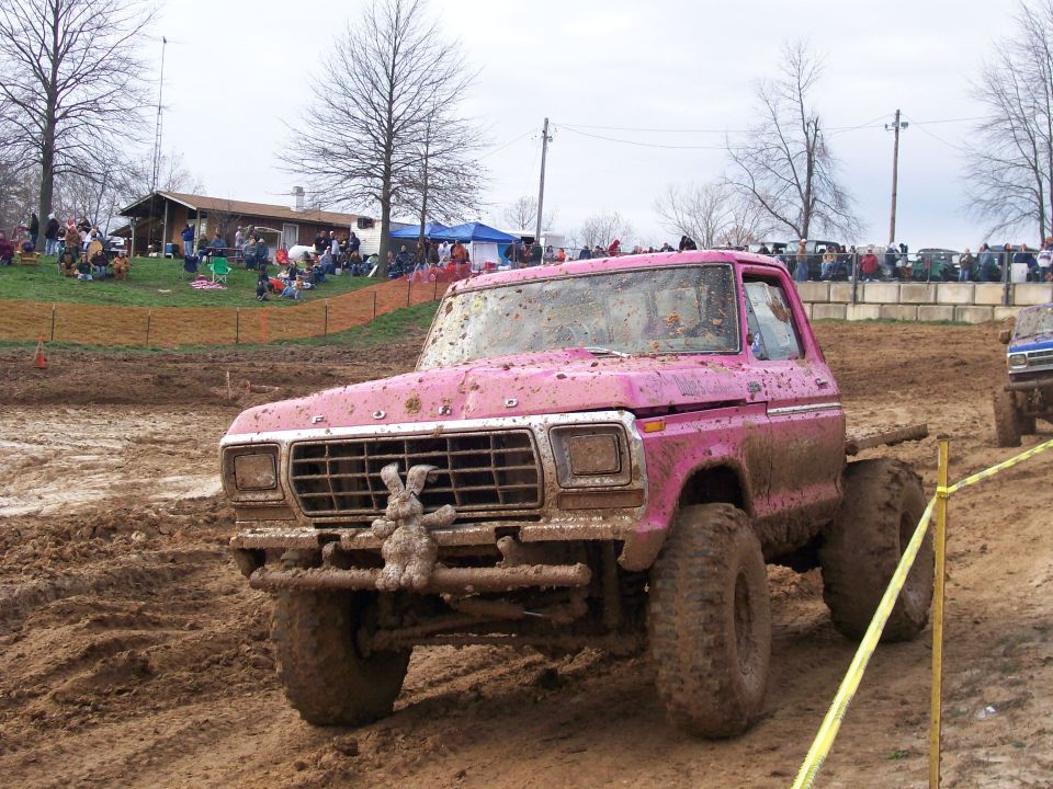 Pink pickup truck with bunny ornament in mud