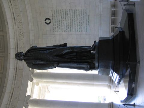 1991 Ford LTD Crown Victoria - bronze statue of a standing robed figure on a pedestal inside a marble columned memorial with inscribed walls; the photo is sideways.