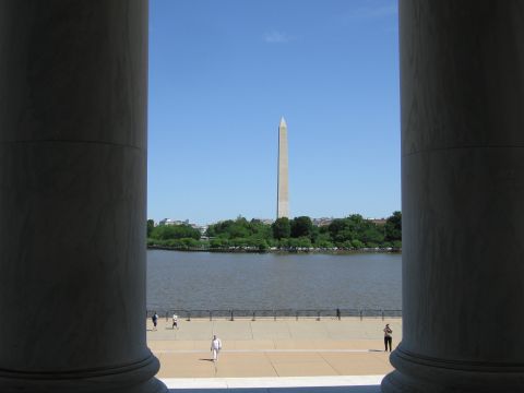 1991 Ford LTD Crown Victoria - Washington Monument seen across the water of the Tidal Basin, framed between two large marble columns with people on the plaza below.
