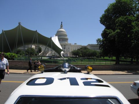 1991 Ford LTD Crown Victoria - Close view of a white police car roof painted with the number 012 and twin spotlights, the U.S. Capitol dome rising in the background.