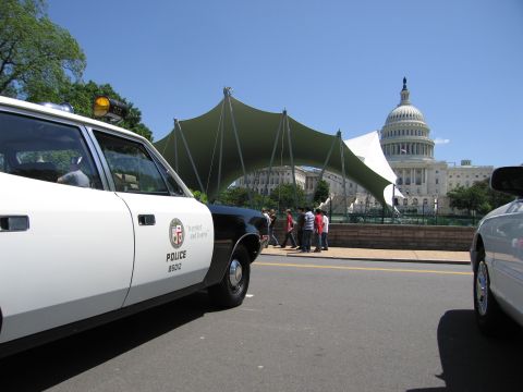 1991 Ford LTD Crown Victoria - black-and-white Los Angeles Police Department patrol car sits in front of the U.S. Capitol dome under a clear blue sky.