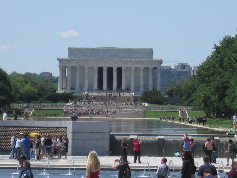 1991 Ford LTD Crown Victoria - Crowds gather around fountains near the Lincoln Memorial and a long reflecting pool on a sunny day.