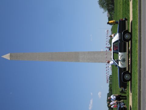1991 Ford LTD Crown Victoria - sideways-oriented photo shows a black-and-white police sedan parked on grass before the Washington Monument.