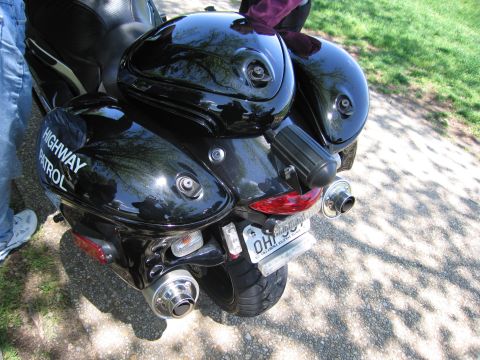 1991 Ford LTD Crown Victoria - rear of a black Highway Patrol sportbike shows hard saddlebags, twin exhausts, and an Ohio license plate.