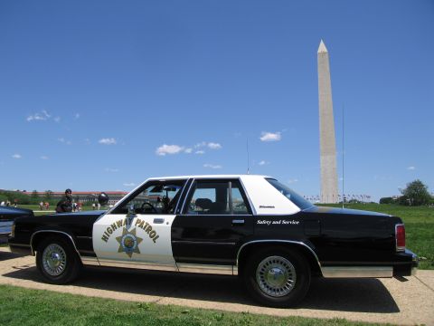 1991 Ford LTD Crown Victoria - Profile of a black-and-white Ford police sedan lettered Highway Patrol and Safety and Service near the Washington Monument.