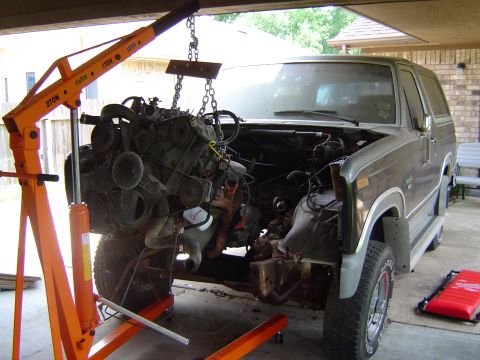 1986 Ford Bronco - Engine hoist lifting the engine out of a 1986 Ford Bronco.