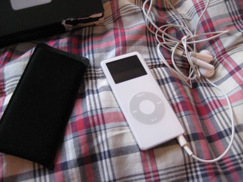 1996 Ford Bronco - A white iPod Classic with its accessories rests on a red, white, and blue plaid background.
