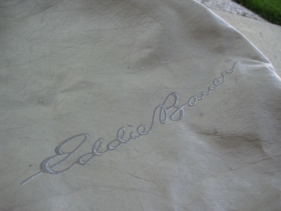 Embroidered Eddie Bauer logo on light-colored fabric
