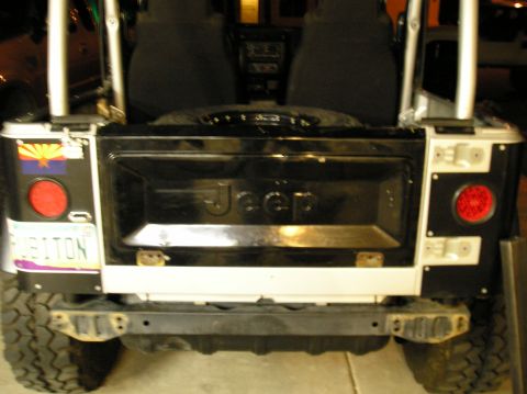 1986 Toyota Hilux - The rear of a Jeep is shown, its tailgate and taillights. An Arizona license plate is attached.