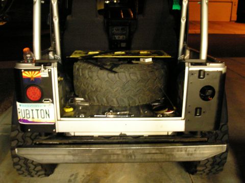 1986 Toyota Hilux - The rear of a Jeep Wrangler shows a spare tire and an Arizona license plate.