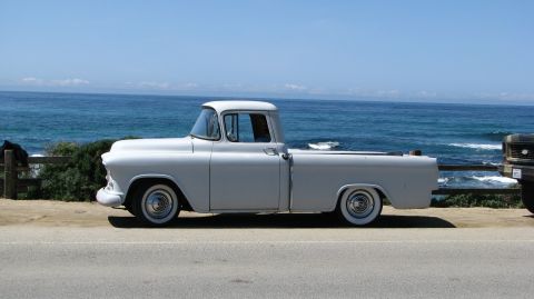2005 Chrysler PT Cruiser - Classic white Chevrolet pickup truck parked seaside with the ocean in the background.