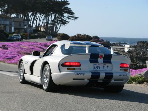 2005 Chrysler PT Cruiser - Dodge Viper GTS-R seen on a scenic coastal drive with purple flowers lining the road.