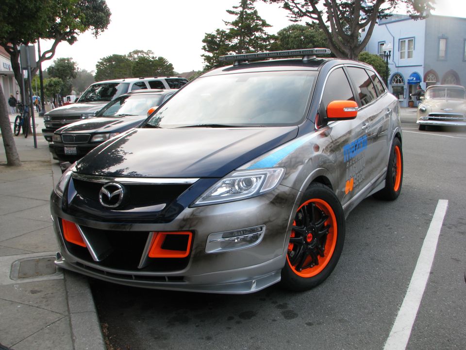 Mazda CX-9 with orange accents and custom graphics parked on street