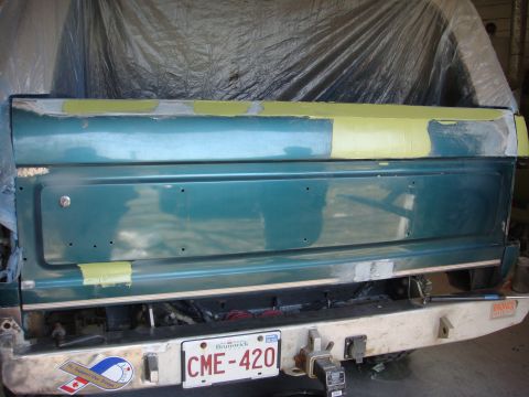 1996 Ford Bronco - The rear of a vehicle is shown with body filler and tape applied to the tailgate, indicating repair work.