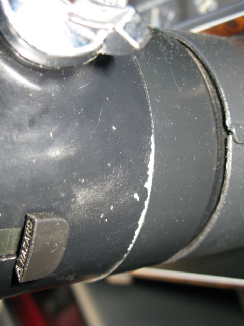 1991 Ford F-150 - Hazard light button on a steering column shroud, showing wear and paint chips.
