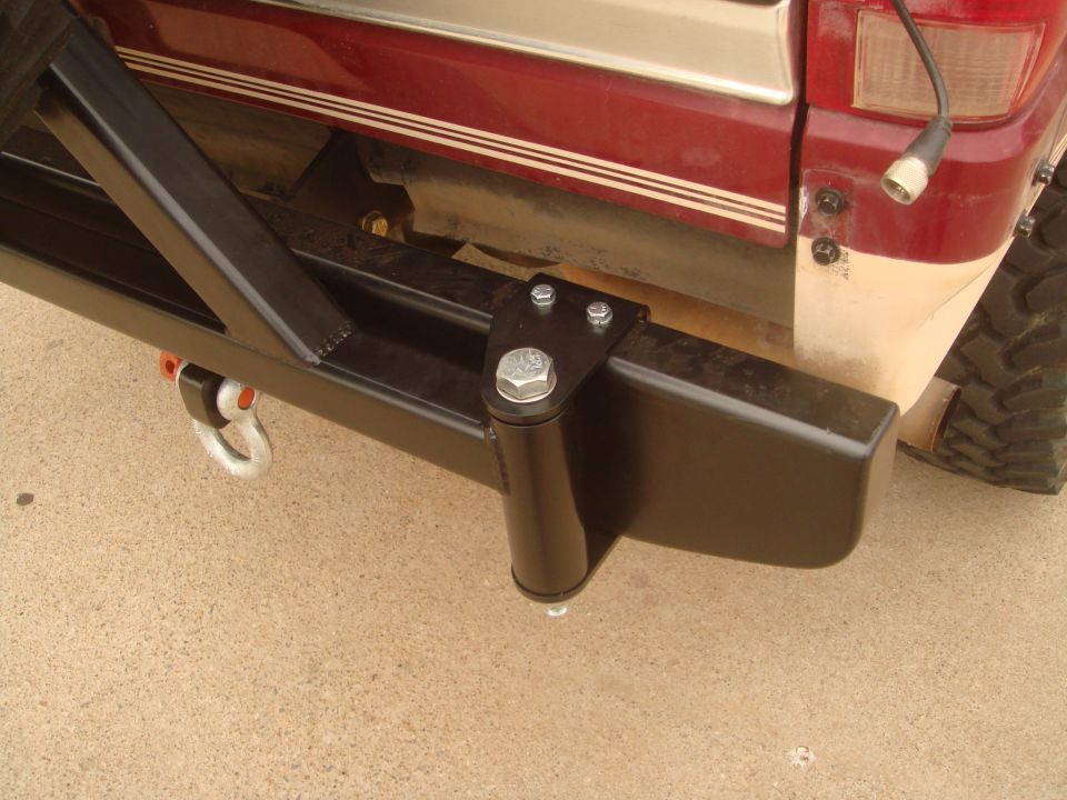 Aftermarket rear bumper with tow hitch receiver and D-ring shackle mount