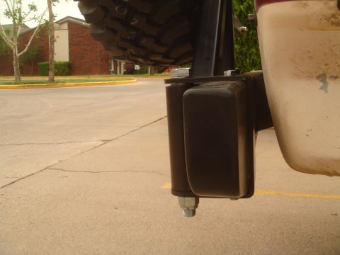 1992 Ford Bronco - A spare tire mount is visible on the rear of a vehicle, with a parking lot and building in the background.