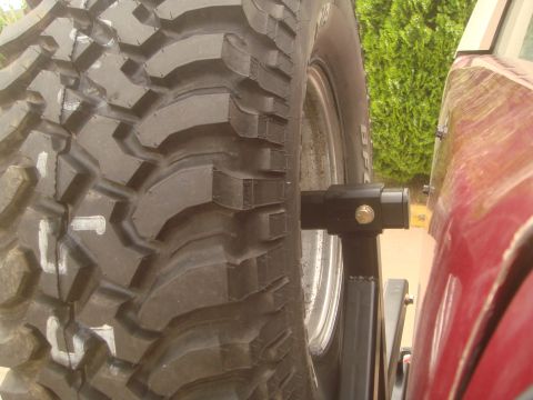 1992 Ford Bronco - Close-up of a spare tire mounted on the rear of a red vehicle.