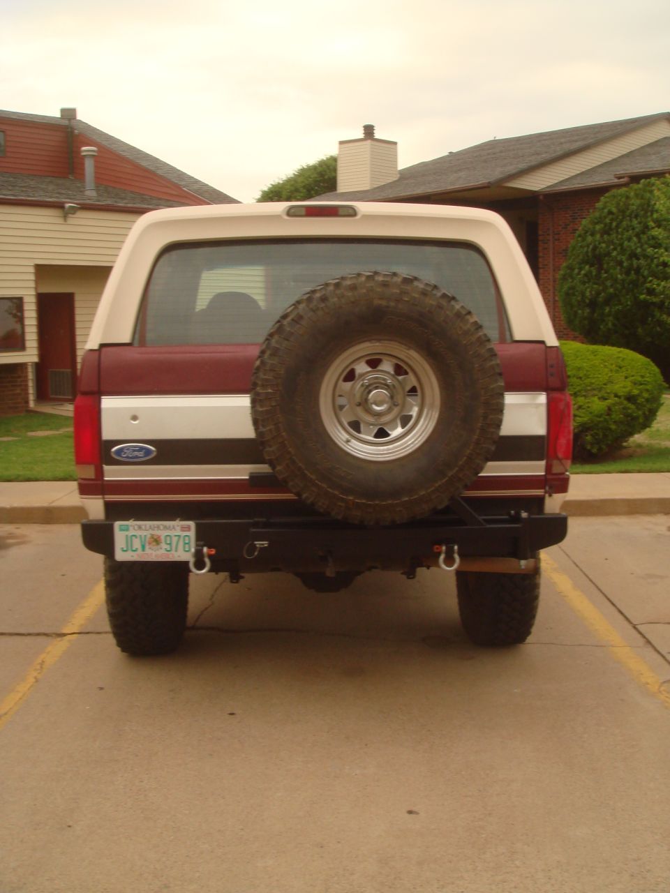 1992 Ford Bronco rear view showing spare tire mounted on custom bumper. Oklahoma license plate reads JCV 978