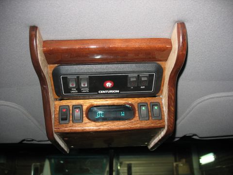 1995 Ford C-350 (Centurion Conversions) - Overhead console with wood trim, Centurion badging, and various light and auxiliary switches.
