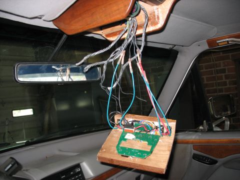 1995 Ford C-350 (Centurion Conversions) - Wiring and circuit board assembly hanging from the overhead console of a vehicle.