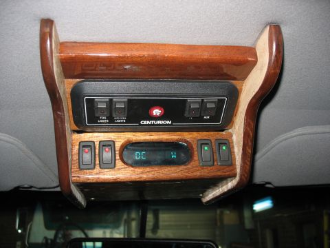 1995 Ford C-350 (Centurion Conversions) - Overhead console with multiple switches and a digital display, likely from a van conversion.