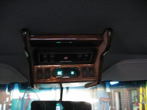 1995 Ford C-350 (Centurion Conversions) - Interior overhead console with wood trim, climate controls, and a Centurion radio.