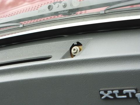 1991 Ford F-150 - Close-up of a vehicle's dashboard interior, showing a screw and the BOSCH brand on the windshield wiper assembly.