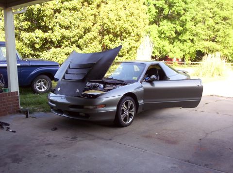 1995 Ford Probe - Gray 1995 Ford Probe with hood and door open, parked outside next to a blue pickup truck.