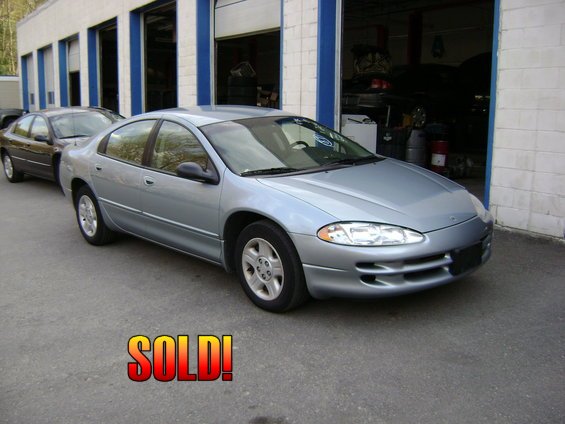 Silver Dodge Intrepid parked outside a garage, with "SOLD!" overlay