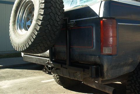 1986 Ford Bronco - Rear view of a 1986 Ford Bronco showing a custom bumper and spare tire mount.