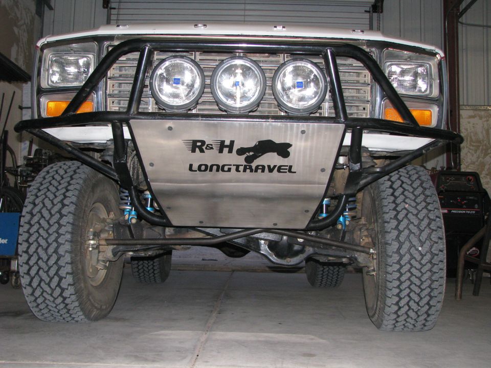 1980 Ford Bronco front view with custom off-road bumper, skid plate, and spotlights.