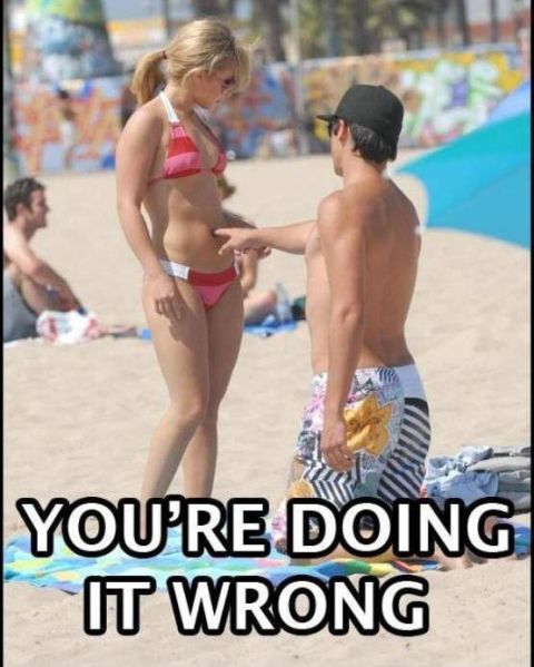1995 Ford Bronco - A man and a woman in swimsuits are on a beach, with the man pointing at the woman's stomach. Text overlays the bottom of the image.