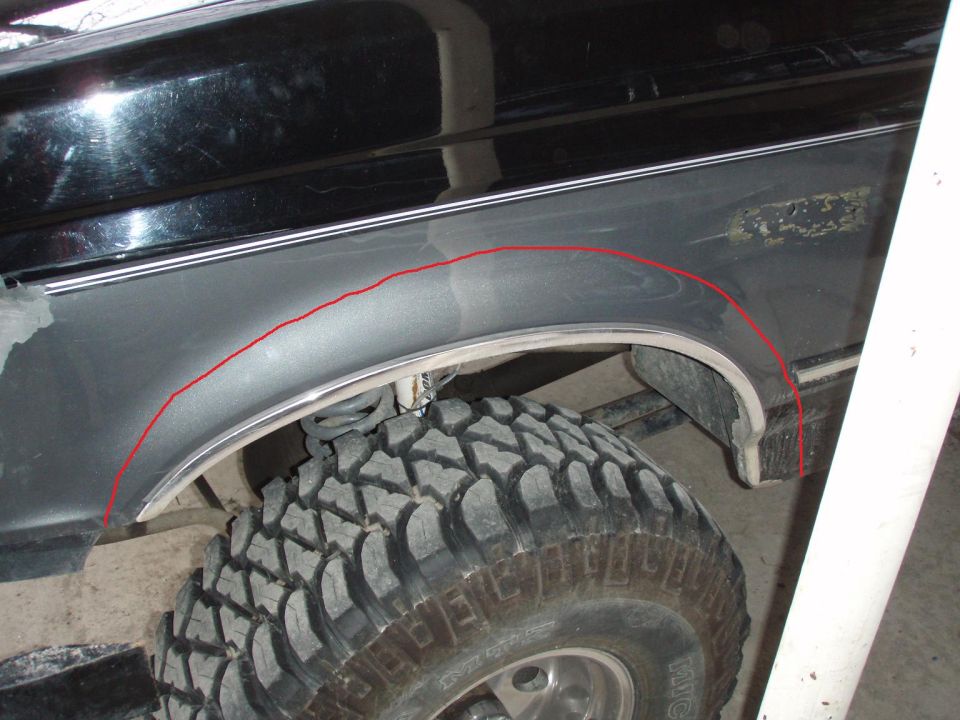 Gray Ford front fender with red cut line drawn above a Mickey Thompson mud tire